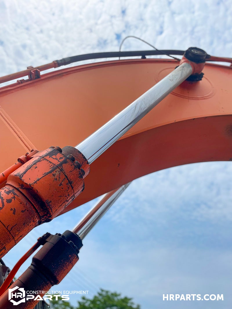Two excavator cylinders work together.
