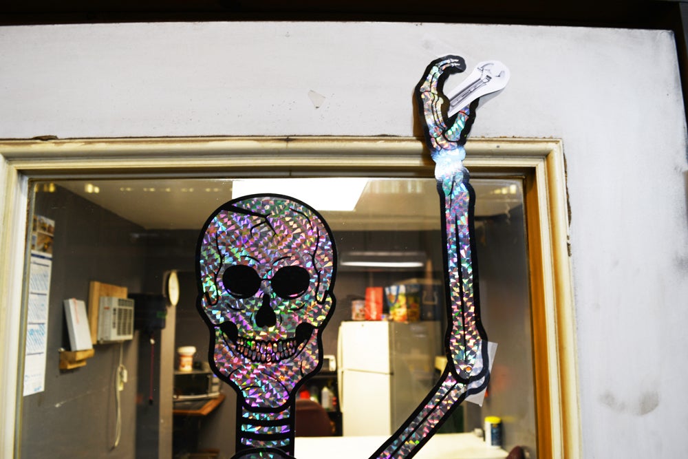 a skeleton holds a crescent wrench