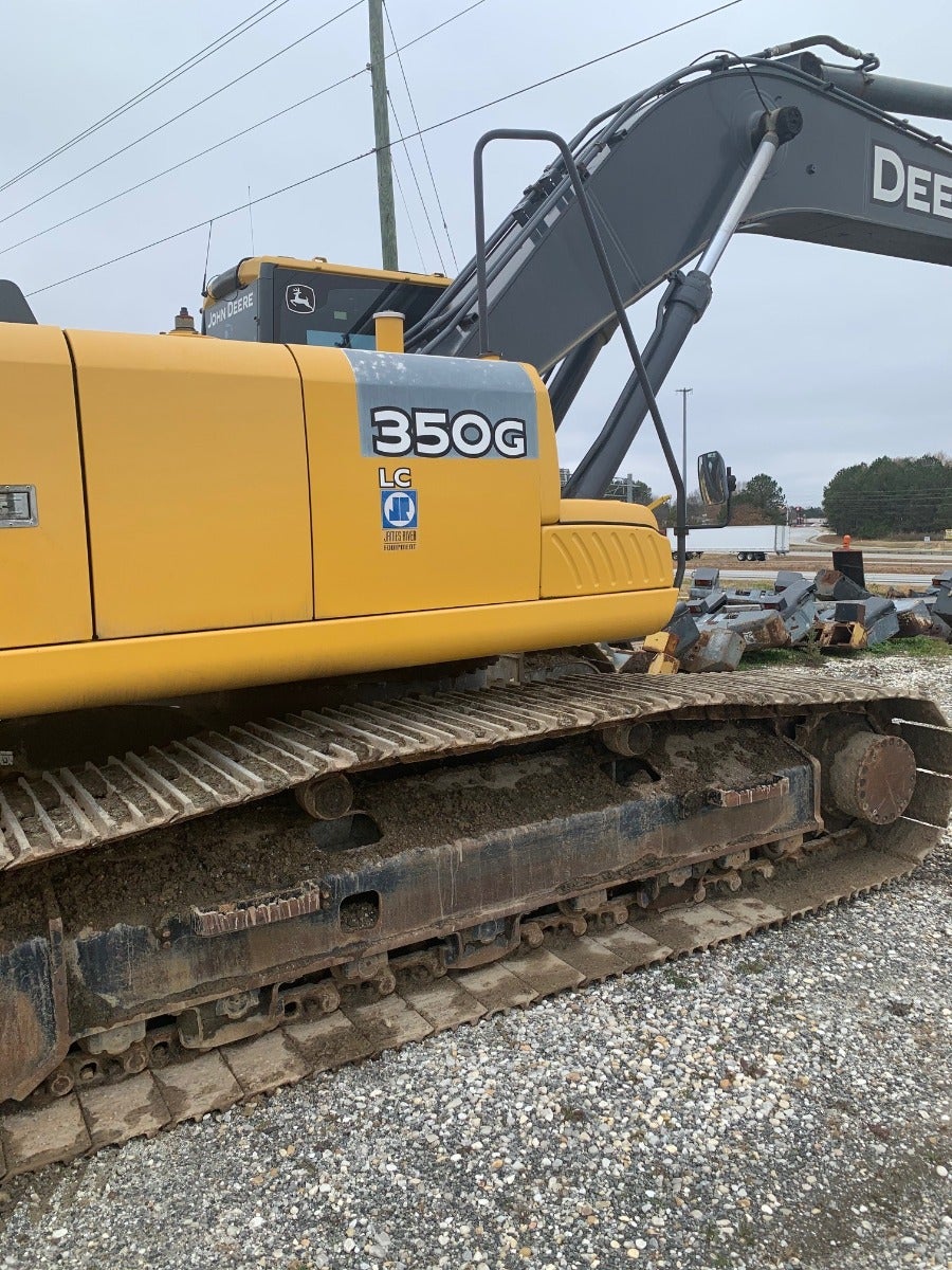 John Deere 350G LC leaves the heavy equipment salvage yard 3